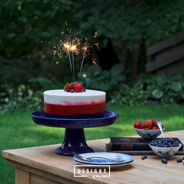 A Very Patriotic Fourth of July Ombre Cake. Break out the sparklers! This patriotic Fourth of July Ombre Cake, with it's red, white and blue color, is sure to be quite the show. A delicate white cake with a hint of lemon and almond is layered with strawberry and blueberry jam. So good and so very patriotic! Find this recipe at www.designsofanykind.com