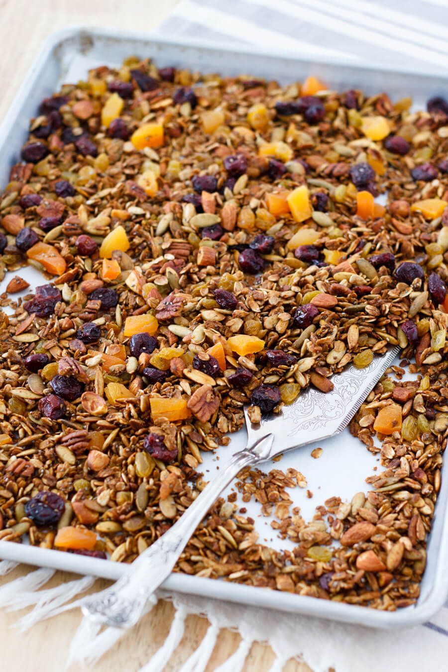 This Honey Harvest Granola is easy to make and packed full of healthy ingredients such as nuts, chia seeds, coconut oil, and molasses. Great on yogurt or as a crunchy snack. Recipe at www.designsofanykind.com