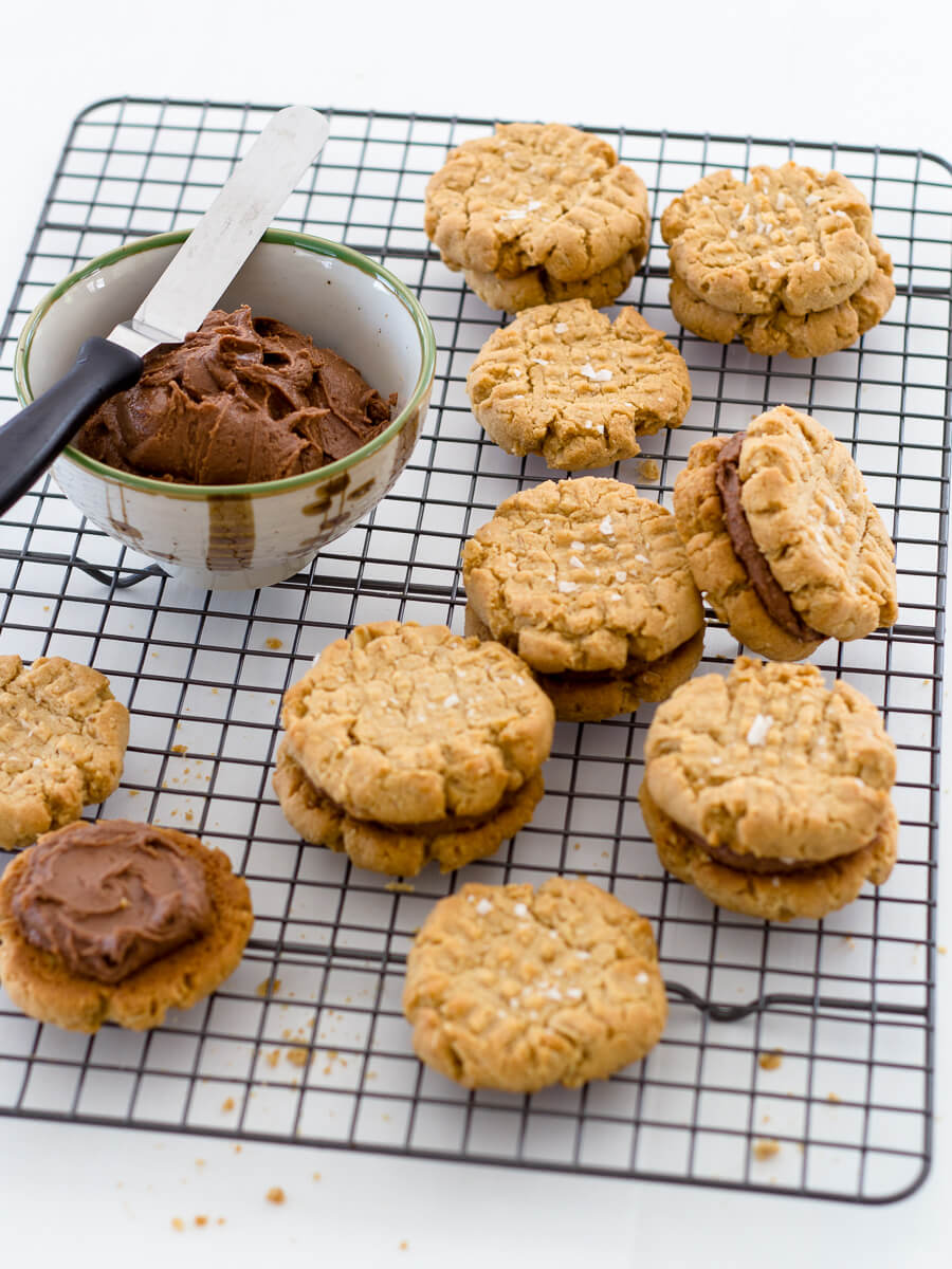 Salted Nutella Nutter Butter cookies get a thick peanut butter-Nutella filling and a light sprinkle of sea salt for a rich, irresistible salty-sweet combo! Recipe at www.designsofanykind.com