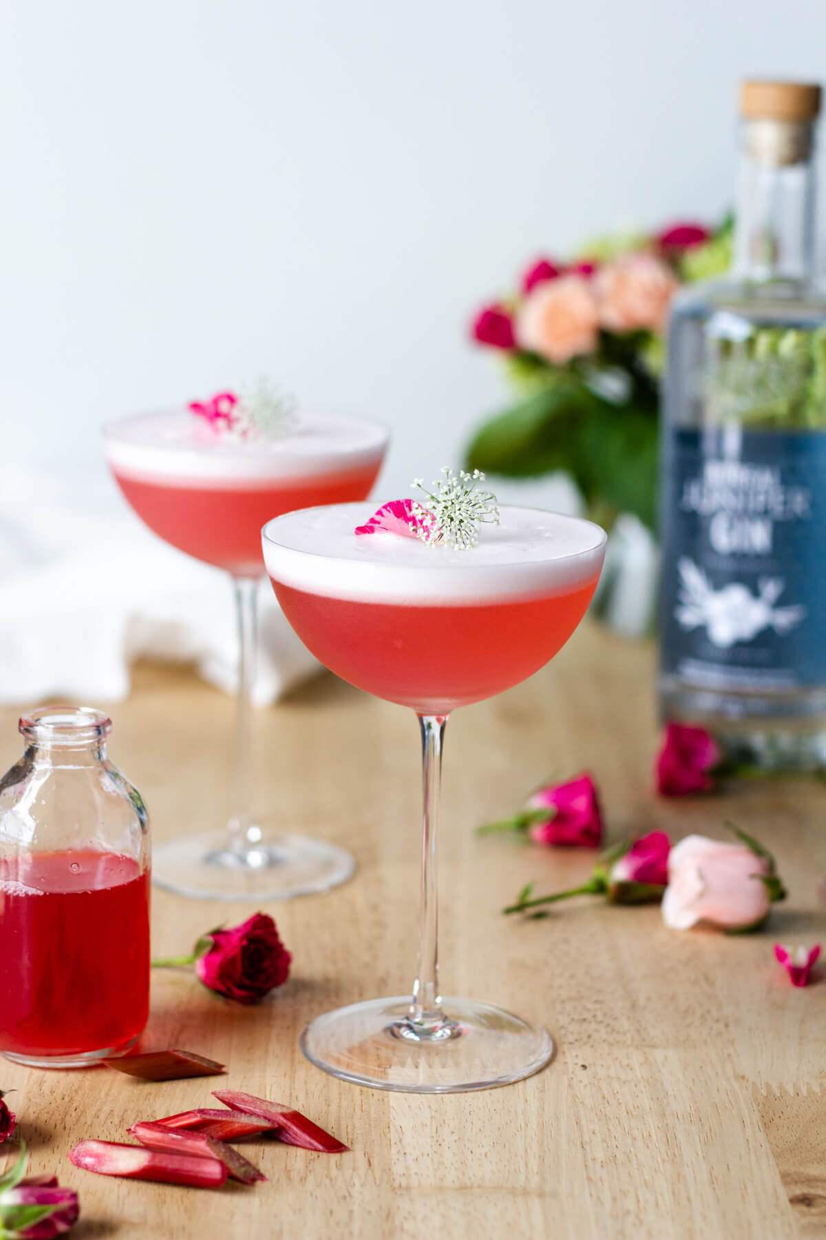The Rhubarb Rose Gin Sour makes for a refreshingly beautiful cocktail. This is a fun way to use up all of those rhubarb plants growing in your garden. Cocktail recipe at www.designsofanykind.com